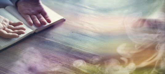 Reading religious literature. A man studies the Koran and sorts out the rosary.