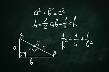 Basic triangle area formulas and Pythagorean theorem written on chalkboard