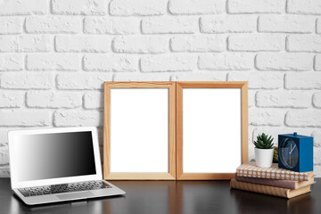 Poster - Worktable with laptop, stationery and decorations in home office with blank photo frame