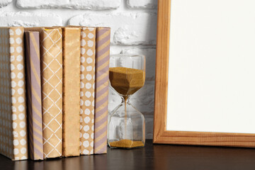 Poster - Books with picture frame on wooden table