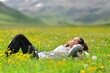 © Antonioguillem - Hiker resting lying in a field in the mountain
