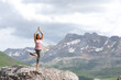 © Antonioguillem - Yogi practicing yoga in the top of a high mountain