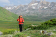 © Antonioguillem - Front view of a hiker walking in a green mountain