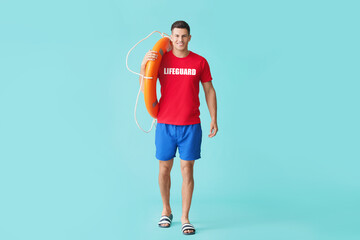 Wall Mural - Beach rescuer with lifebuoy on light blue background