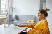 Businesswoman Using Desktop PC At Home