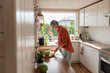 © Westend61 - Woman preparing salad in kitchen at home