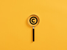 Magnifying Glass Magnifies Copyright Symbol. Patenting Or Copyright Protection.
