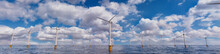 Wind Turbines. Offshore Wind Farm On A Cloudy Afternoon. Renewable Electricity Concept.