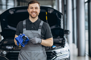 Car mechanic at car service checking up the car