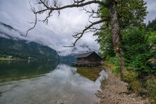 Austria, Styria, Altaussee, Low Clouds Over Shore Of Lake Altaussee With Boathouse In Background