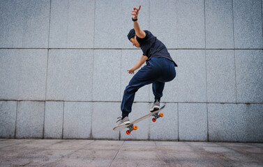 Wall Mural - Asian woman skateboarder skateboarding in modern city