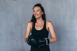 © undrey - Portrait of young sportswoman in boxing gloves.