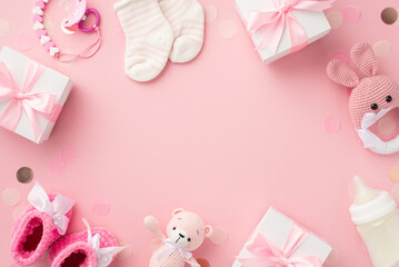 Baby girl concept. Top view photo of gift boxes socks booties knitted bunny rattle toy teddy-bear pacifier chain bottle and confetti on isolated pastel pink background with copyspace in the middle