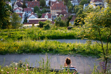 Woman relaxing in the city of Ravensburg, picture taken at the Veitsburg.