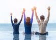 © Chinnapong - Family summer holiday travel vacation lifestyle with happy dad, mom and young daughter relaxing together having fun in beachfront swimming pool with ocean and blue sky view