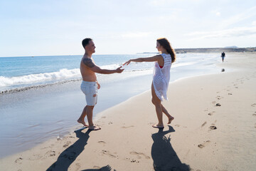 Wall Mural - Happy young couple at the sea vacations