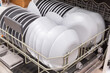 © drotik - open dishwasher with clean dishes at home kitchen