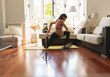 © Westend61 - Pregnant woman doing stretching exercise recording tutorial through mobile phone at home