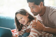 © Westend61 - Mature man with cheerful daughter using digital tablet at home