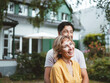 © Westend61 - Cheerful mature woman with man standing in front of house