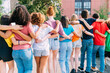 © Westend61 - Multiracial friends with arm around walking on footpath