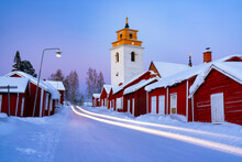 Car Trails Lights On The Icy Road Crossing The Medieval Gammelstad Church Town Covered With Snow, UNESCO World Heritage Site, Lulea, Sweden, Scandinavia