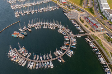 Aerial view of marina for luxury yachts, house boats and sailboats. Marina Burgtiefe-Südstrand with outstanding berthing conditions, spectacular scenery close to the South Beach, Fehmarn, Germany. 