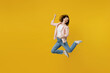 Full body young happy excited singer musician woman she 30s in striped shirt white t-shirt jump high play guitar gesture isolated on plain yellow background studio portrait. People lifestyle concept