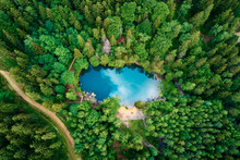 Blue Lake In The Middle Of Green Forest, Aerial View. Wild Colorful Lake In Mountain Park In Poland. Beautiful Nature Landscape