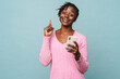 African american happy woman gesturing and holding cellphone