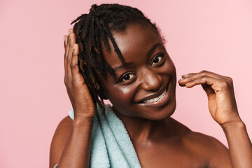 Wall Mural - Black shirtless woman with towel smiling and looking at camera