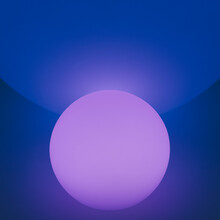Glowing And Illuminated Spherical Coloured Orbs On A Black Background.