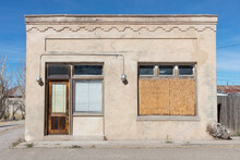 Abandoned Building Facade, Boarded Up Windows And Stonework Pattern.