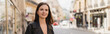 © LIGHTFIELD STUDIOS - cheerful young woman in black leather jacket looking at camera on street in paris, banner.