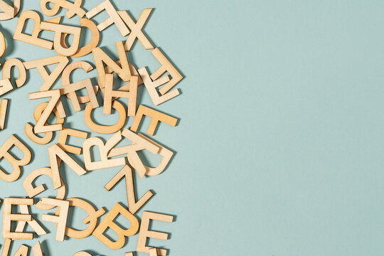 wooden letter all over the green background, alphabet, words
