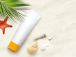 White blank cosmetic tube with sunscreen, suncream for body, starfish and green brunch palm on the sandy beach. Copy space.