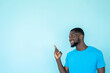 Pointing man. Promotion banner. Content advertising. Discount offer. Happy guy demonstrating blue empty space recommendation background.