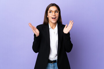 Canvas Print - Business woman isolated on purple background with surprise facial expression