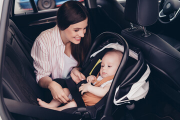 Wall Mural - Photo of cheerful positive mom son wear casual outfits sitting transport fasten seatbelt inside vehicle