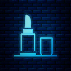 Sticker - Glowing neon Lipstick icon isolated on brick wall background. Vector