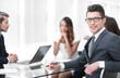 © ASDF - young businessman with his business team sitting at his Desk