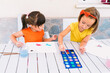 © ADDICTIVE STOCK - Cute girls painting with watercolor