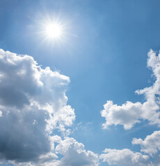 Wall Mural - cloud scape background with bright sun and cumulus on blue sky, square format