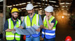© atitaph - Male and female engineers chat with factory workers as they use machine drawings, planning for industrial maintenance
