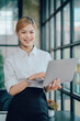 © Kritdanai - Portrait of smiling pretty young business woman sitting on workplace