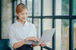 © Kritdanai - Portrait of smiling pretty young business woman sitting on workplace