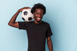 © Asier - Young african american man playing football isolated on blue background