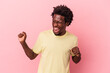 © Asier - Young african american man isolated on pink background dancing and having fun.