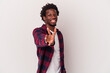 © Asier - Young african american man isolated on white background  joyful and carefree showing a peace symbol with fingers.