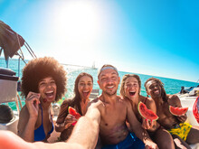 Happy Multiracial Friends Eating Watermelon While Doing Sea Tour With Sailing Boat - Summer, Travel And Vacation Concept - Main Focus On Center Man Face